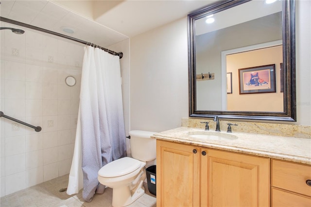 full bathroom with toilet, a tile shower, and vanity