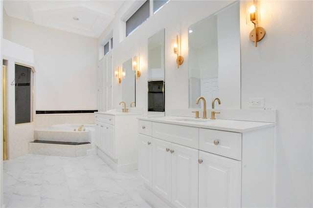 bathroom with marble finish floor, two vanities, a sink, and a bath