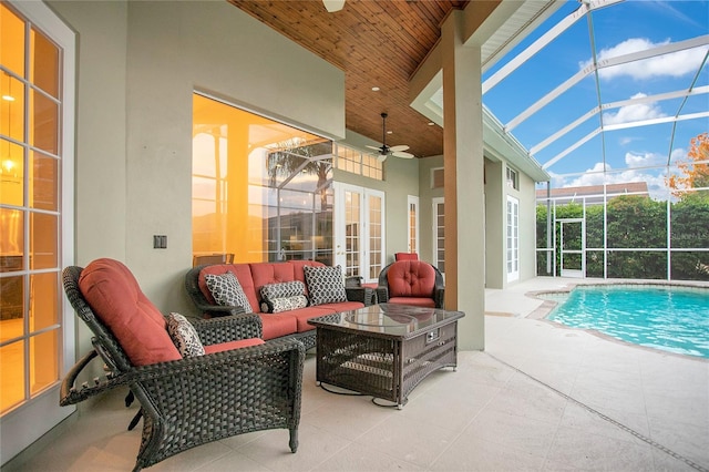 outdoor pool with glass enclosure, french doors, an outdoor hangout area, ceiling fan, and a patio area