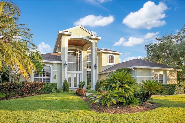 view of front of house featuring french doors and a front lawn