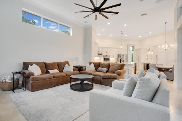 living area featuring visible vents, a high ceiling, recessed lighting, ornamental molding, and a notable chandelier