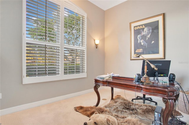 carpeted home office featuring baseboards