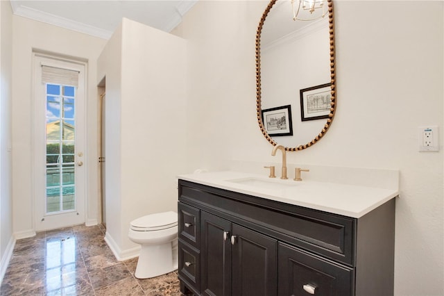 full bath featuring crown molding, baseboards, toilet, vanity, and a shower