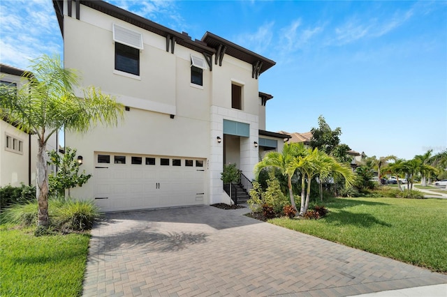 view of front of property with a garage and a front lawn