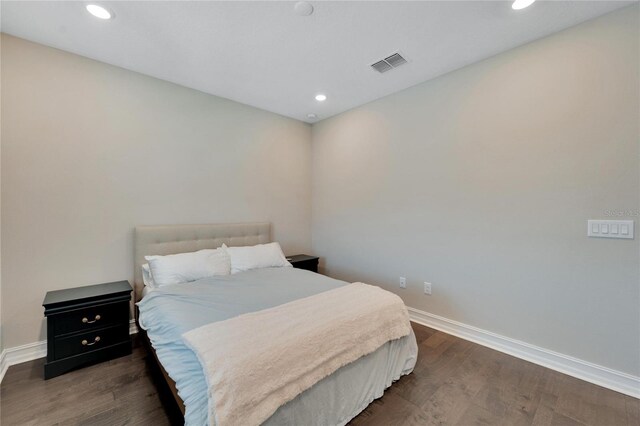 bedroom with dark hardwood / wood-style flooring