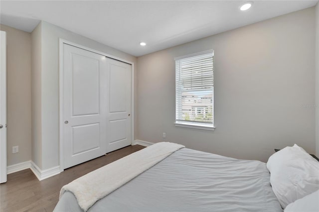 bedroom featuring dark hardwood / wood-style floors and a closet