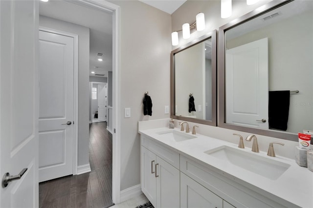 bathroom with vanity and hardwood / wood-style floors