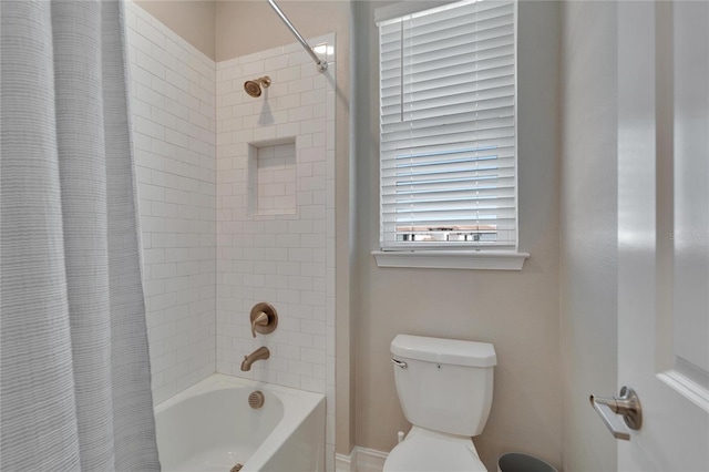 bathroom with shower / tub combo with curtain and toilet