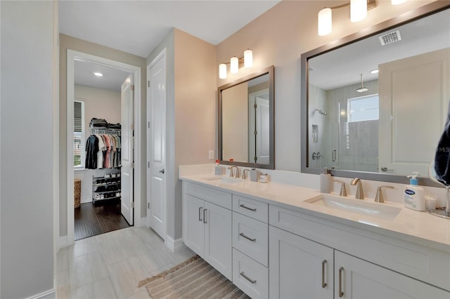 bathroom with hardwood / wood-style flooring, a wealth of natural light, vanity, and a shower with shower door