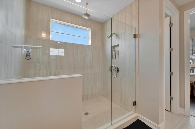 bathroom featuring a shower with door and tile patterned floors