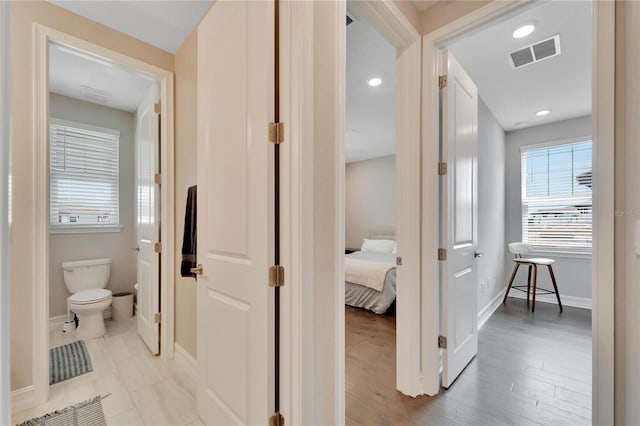 hallway with light hardwood / wood-style floors