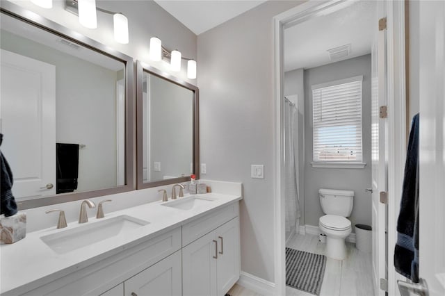 bathroom featuring curtained shower, vanity, and toilet