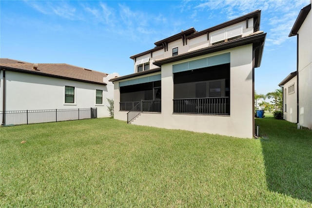 back of property featuring a lawn, central AC, and a sunroom