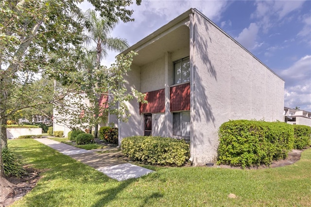 view of property exterior featuring a lawn