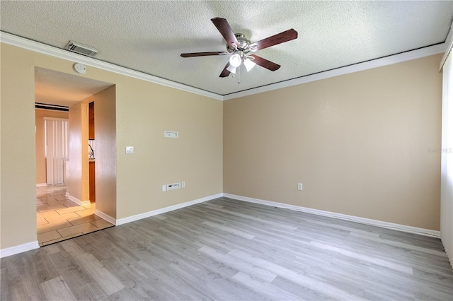 unfurnished room featuring ceiling fan, light wood-type flooring, ornamental molding, and a textured ceiling