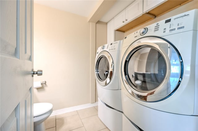 washroom with light tile patterned floors and independent washer and dryer