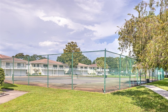 view of sport court featuring a yard