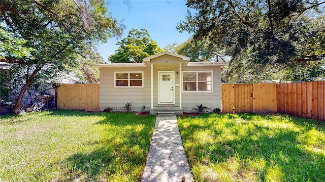 bungalow-style home featuring a front lawn