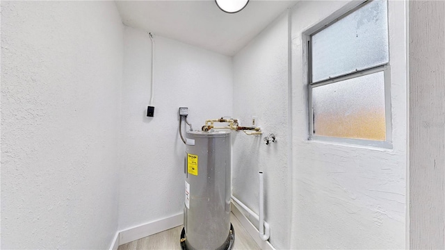 utility room with electric water heater