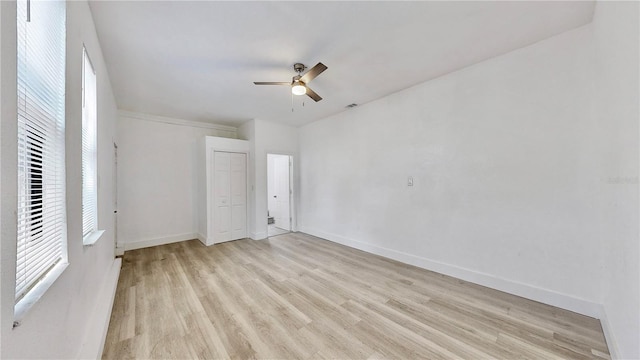 unfurnished bedroom featuring a closet, light hardwood / wood-style floors, and ceiling fan