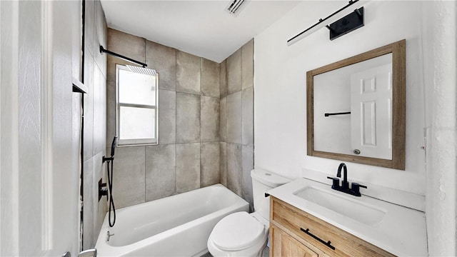 full bathroom featuring vanity, tiled shower / bath combo, and toilet