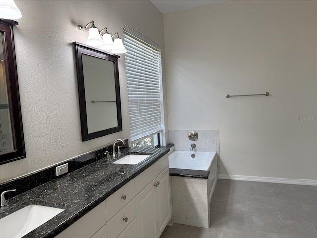 bathroom with tiled bath, tile patterned flooring, and vanity