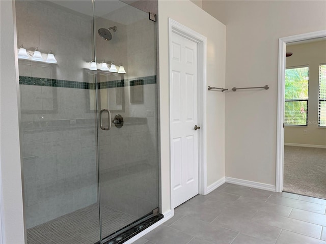 bathroom featuring tile patterned flooring and a shower with shower door