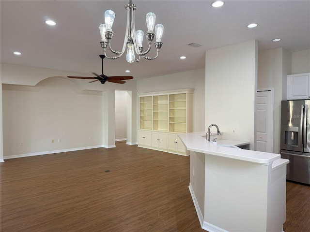 kitchen featuring ceiling fan with notable chandelier, sink, stainless steel refrigerator with ice dispenser, dark hardwood / wood-style floors, and built in shelves