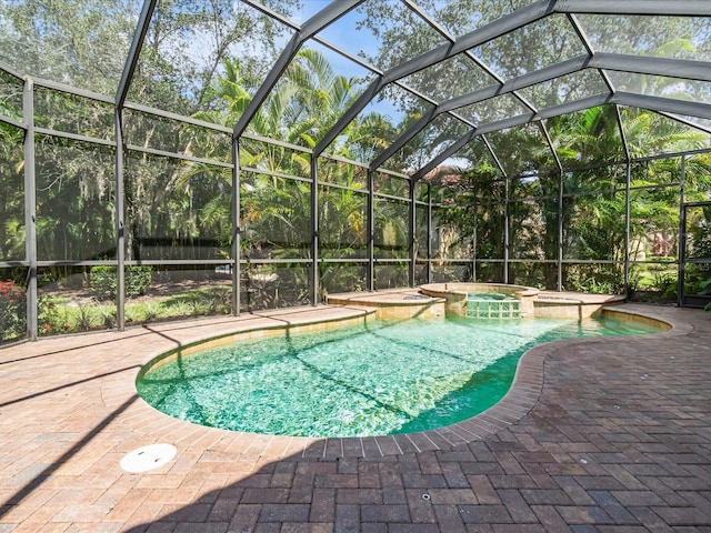 view of pool featuring an in ground hot tub, a lanai, and a patio area