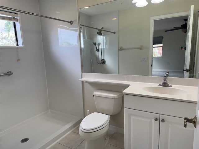 bathroom featuring vanity, a shower, tile patterned floors, ceiling fan, and toilet