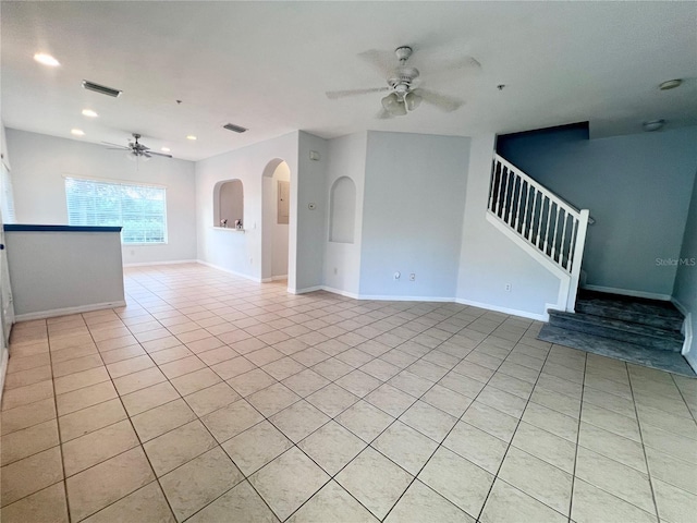 tiled spare room with ceiling fan