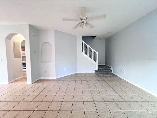 tiled spare room with ceiling fan