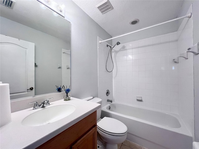 full bathroom with vanity, tiled shower / bath combo, tile patterned flooring, a textured ceiling, and toilet