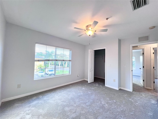 unfurnished bedroom featuring a closet, carpet, and ceiling fan