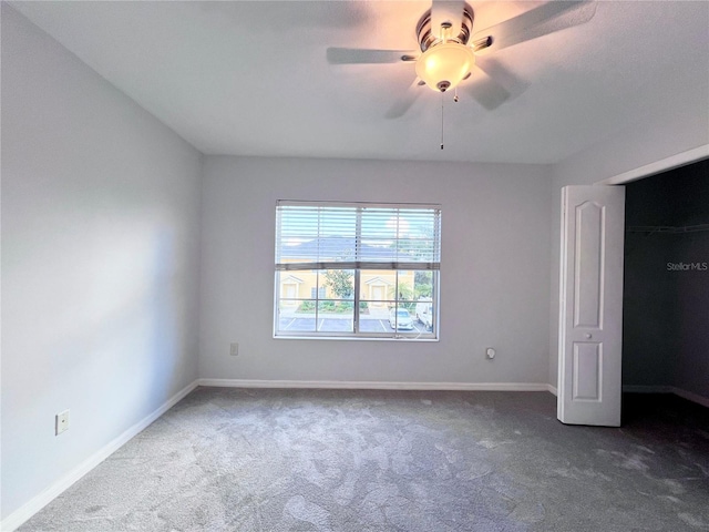 unfurnished bedroom featuring ceiling fan, a closet, and carpet