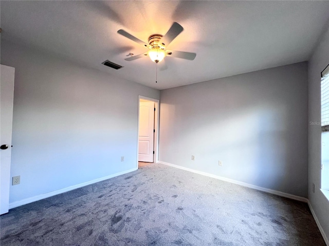 carpeted spare room featuring ceiling fan