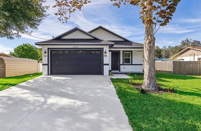 view of front of house with a garage and a front lawn