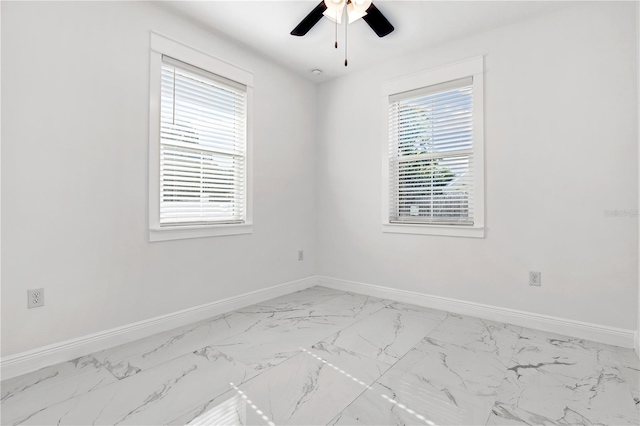 unfurnished room with ceiling fan and plenty of natural light