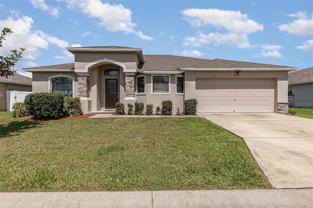 view of front of home featuring a garage and a front lawn