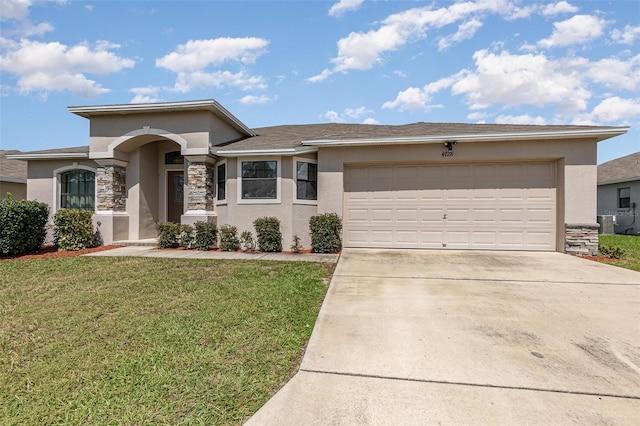 view of front of house featuring a garage and a front lawn