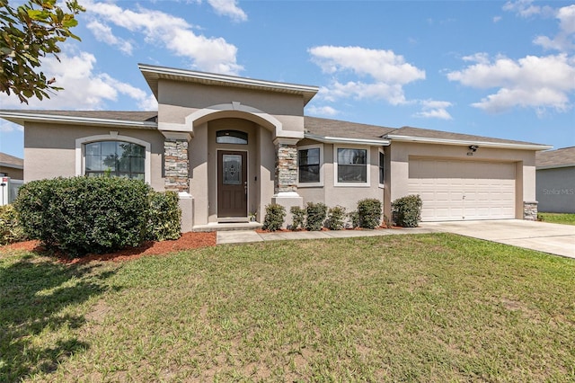 view of front of home with a front yard and a garage