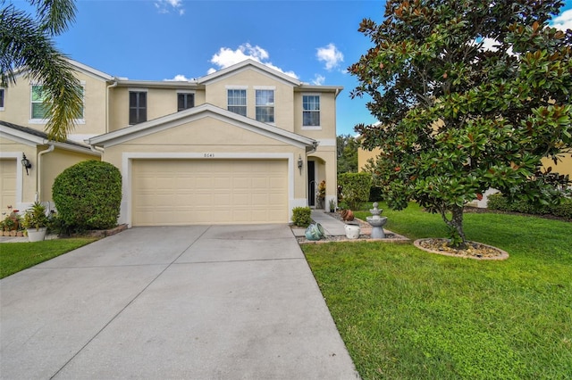 view of front of property featuring a front yard and a garage