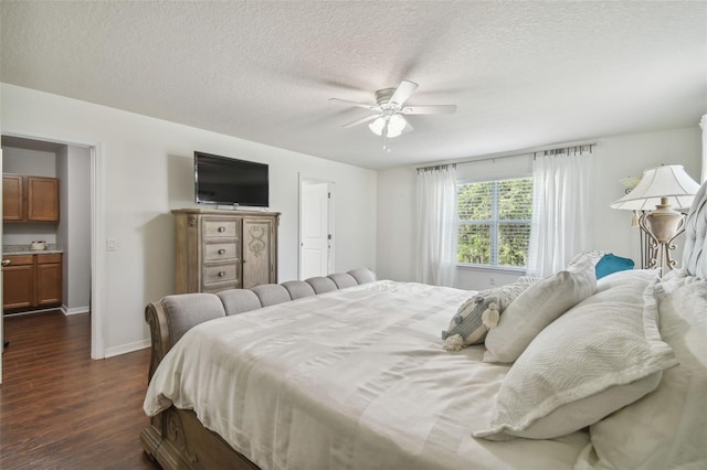 bedroom featuring a textured ceiling, dark hardwood / wood-style floors, ceiling fan, and ensuite bath