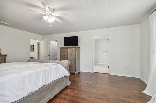 bedroom featuring ceiling fan, a textured ceiling, and dark hardwood / wood-style floors