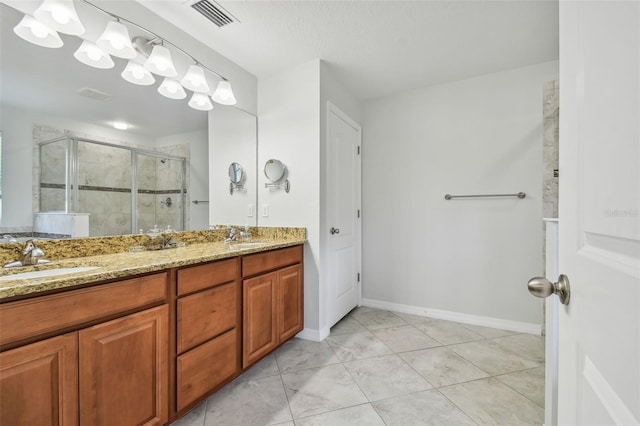 bathroom featuring walk in shower, vanity, and tile patterned floors