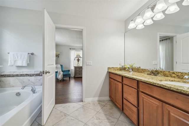 bathroom with vanity, a bathtub, and hardwood / wood-style flooring