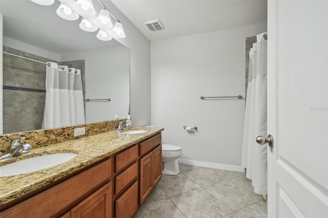 bathroom with vanity, toilet, a textured ceiling, a shower with curtain, and tile patterned flooring