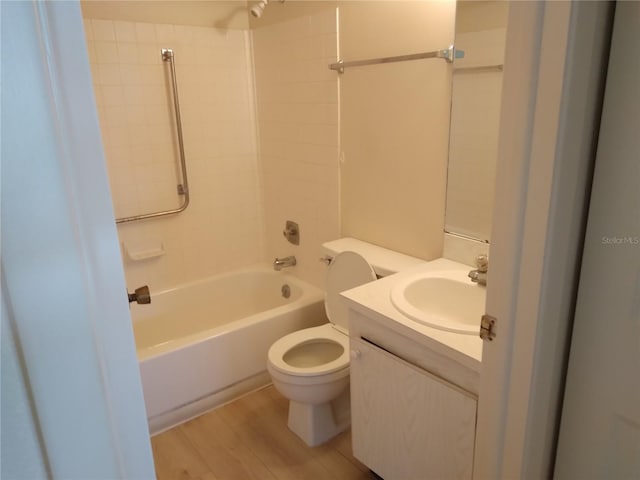 full bathroom featuring wood-type flooring, vanity, toilet, and  shower combination