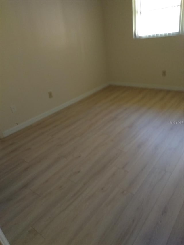 unfurnished room featuring light hardwood / wood-style flooring