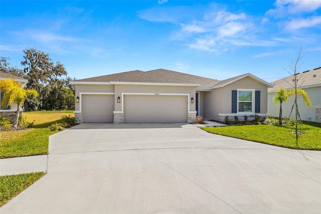 view of front of property with a garage and a front lawn